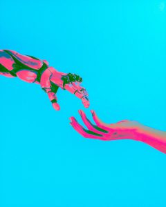 two hands reaching for a flying object in the sky